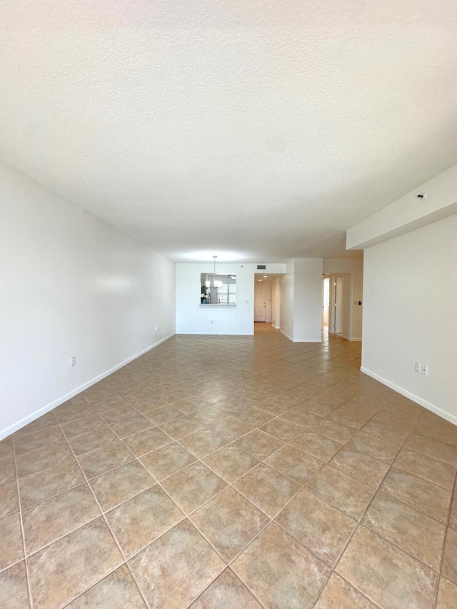 unfurnished living room featuring tile patterned floors and a textured ceiling