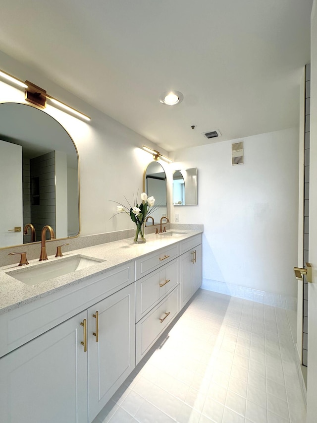 bathroom with tile patterned floors and double vanity