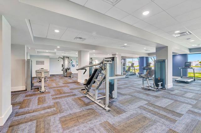 exercise room with a drop ceiling and carpet