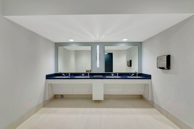 bathroom with hardwood / wood-style flooring and double sink vanity