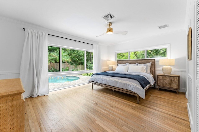 bedroom featuring ceiling fan, crown molding, and light hardwood / wood-style flooring