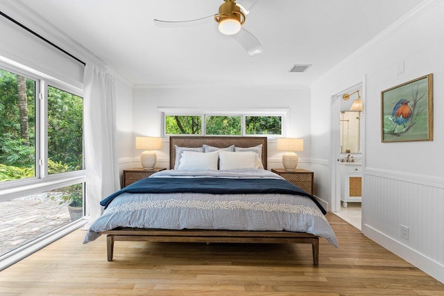 bedroom featuring ceiling fan, multiple windows, and light hardwood / wood-style flooring