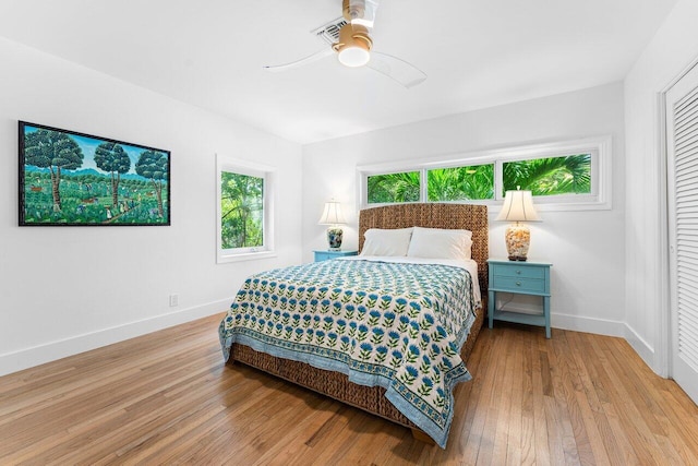 bedroom featuring ceiling fan, a closet, and light hardwood / wood-style floors