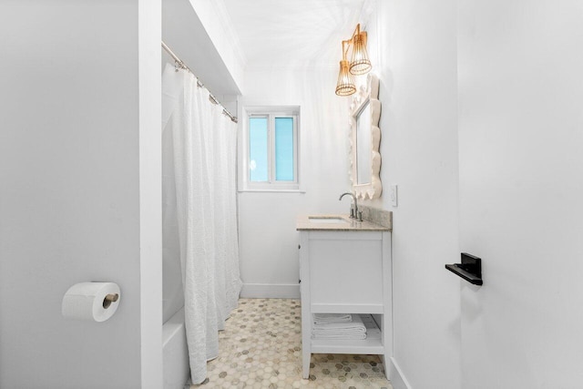 bathroom featuring vanity, crown molding, and shower / bath combo with shower curtain