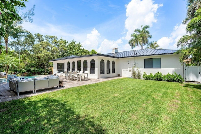 rear view of house featuring a yard and a patio