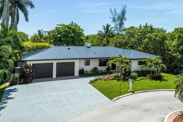 single story home featuring a front lawn and a garage