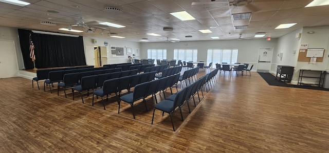 misc room with hardwood / wood-style floors, a drop ceiling, and ceiling fan