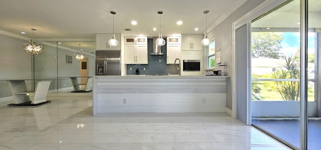 kitchen with stainless steel fridge, backsplash, wall chimney exhaust hood, pendant lighting, and white cabinetry