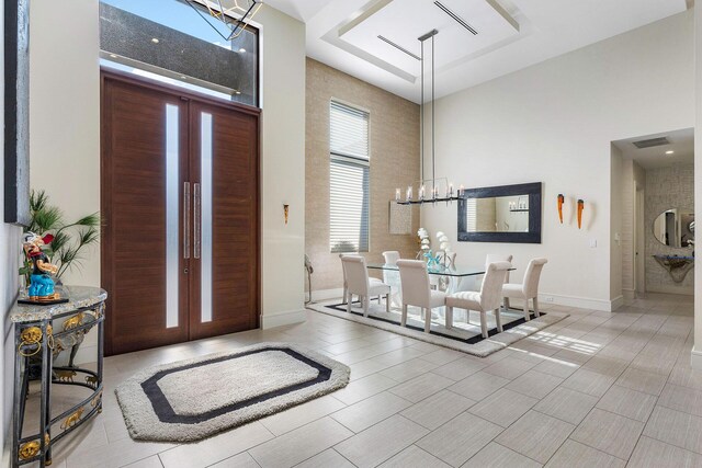 foyer featuring a towering ceiling