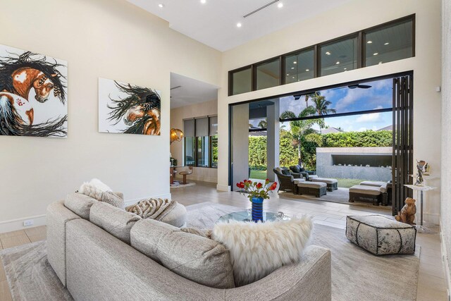 living room featuring light hardwood / wood-style flooring and a towering ceiling