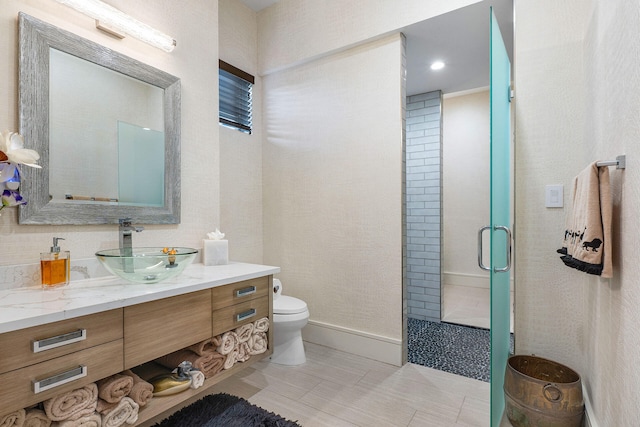 bathroom featuring tile patterned floors, vanity, an enclosed shower, and toilet