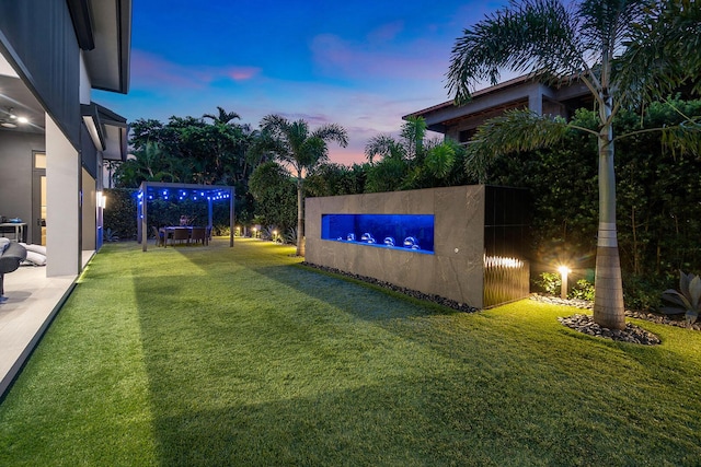 view of yard at dusk