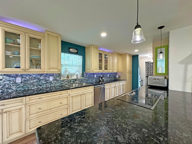 kitchen featuring dark hardwood / wood-style flooring, stainless steel dishwasher, dark stone counters, sink, and tasteful backsplash