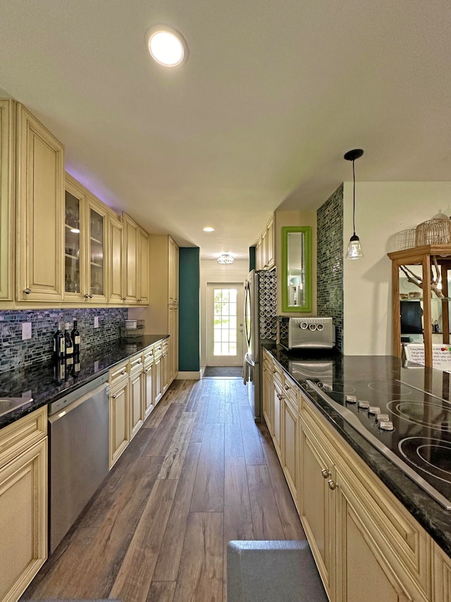 kitchen featuring appliances with stainless steel finishes, light brown cabinetry, and hardwood / wood-style floors