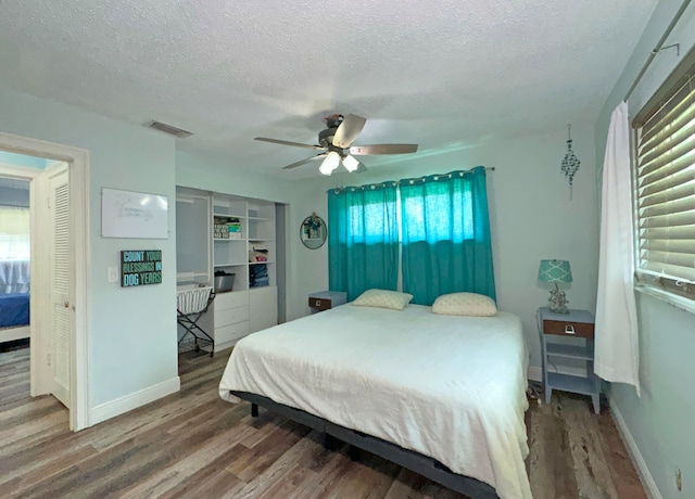 bedroom featuring hardwood / wood-style floors and a textured ceiling