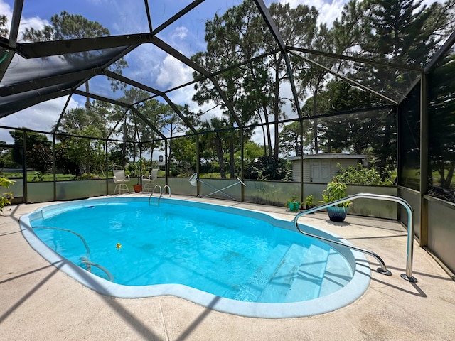 view of swimming pool featuring a lanai