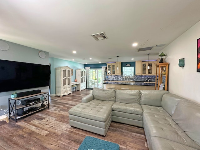 kitchen featuring dark hardwood / wood-style flooring, decorative light fixtures, tasteful backsplash, and appliances with stainless steel finishes