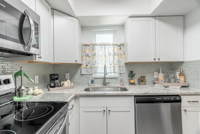 kitchen featuring a sink, appliances with stainless steel finishes, and white cabinets