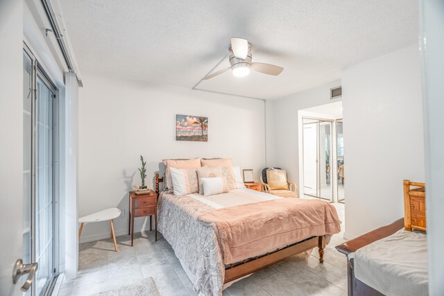 bedroom with visible vents, a ceiling fan, a textured ceiling, a closet, and baseboards