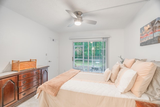 bedroom featuring access to exterior, light carpet, a ceiling fan, and a textured ceiling