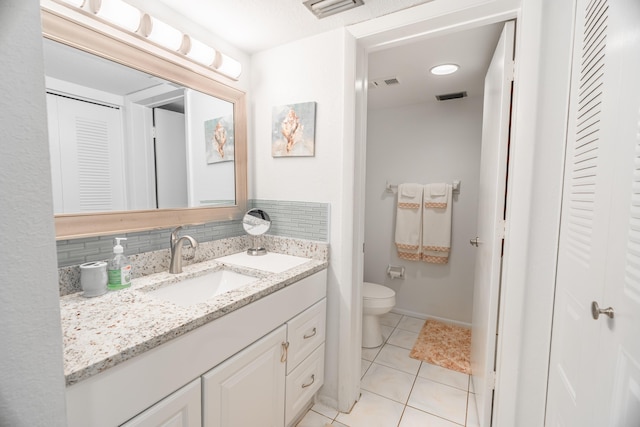 bathroom featuring tile patterned floors, toilet, visible vents, and backsplash