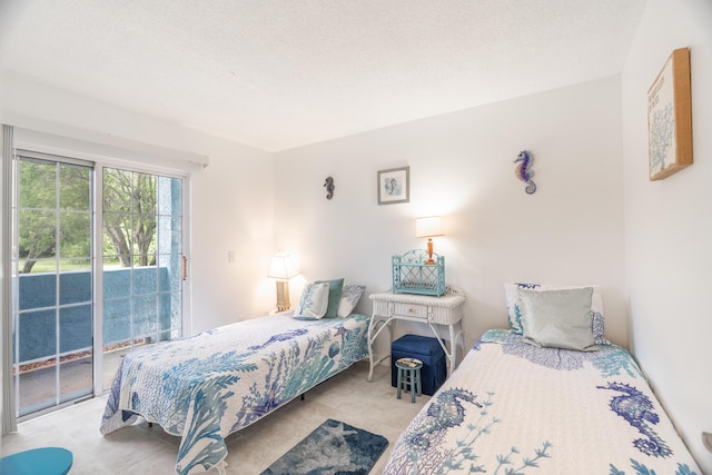 bedroom with access to outside and a textured ceiling