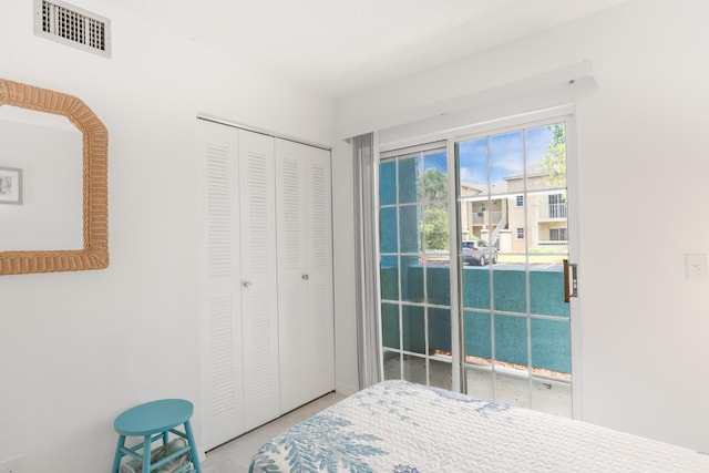 bedroom with access to exterior, visible vents, and a closet