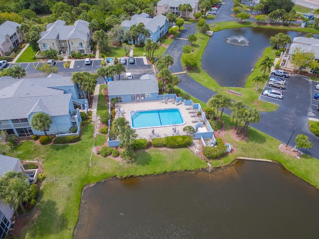 drone / aerial view featuring a residential view and a water view