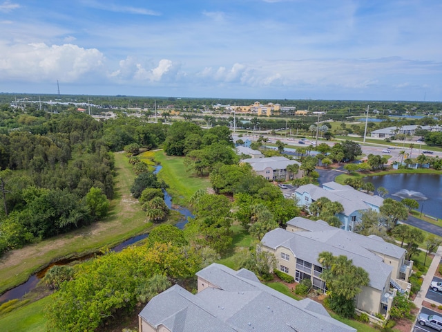 drone / aerial view with a water view and a residential view