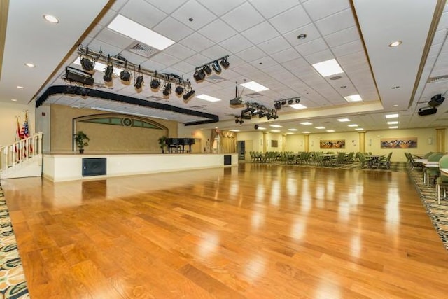 interior space featuring hardwood / wood-style flooring and a drop ceiling