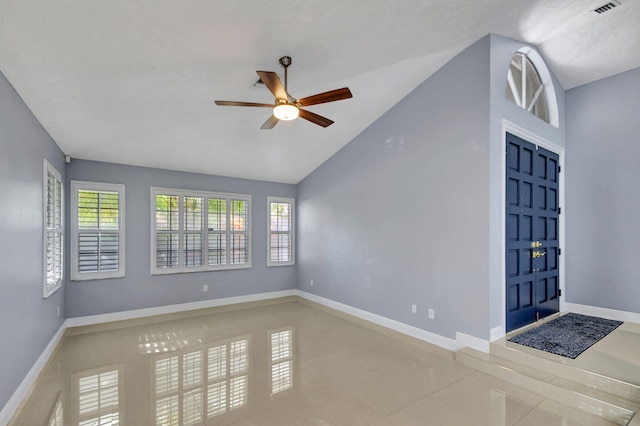 unfurnished room featuring light tile patterned flooring, lofted ceiling, and ceiling fan