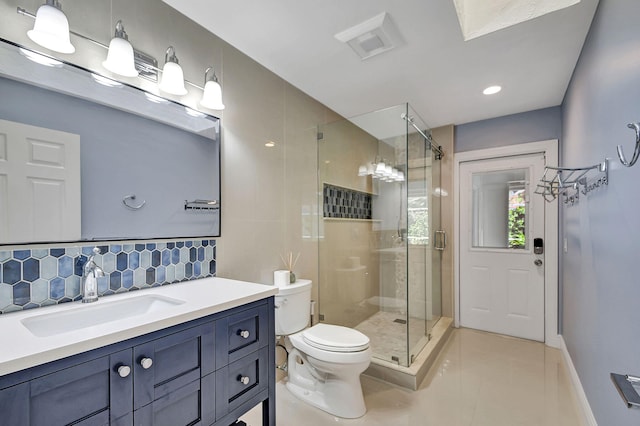 bathroom featuring a shower with door, backsplash, toilet, vanity, and tile patterned floors