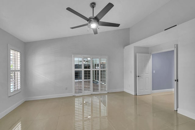 tiled empty room featuring ceiling fan