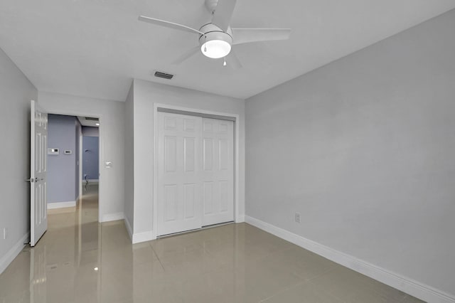 unfurnished bedroom featuring tile patterned floors, a closet, and ceiling fan