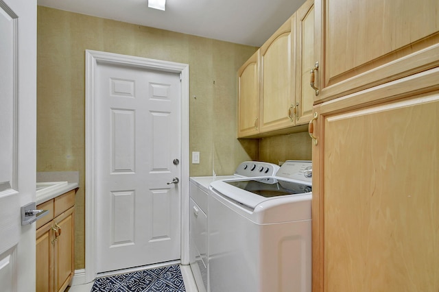 washroom featuring cabinets, washer and dryer, and tile patterned floors