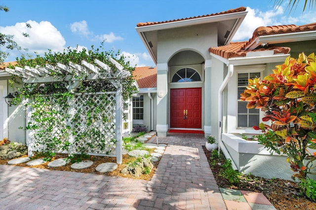 doorway to property with a pergola