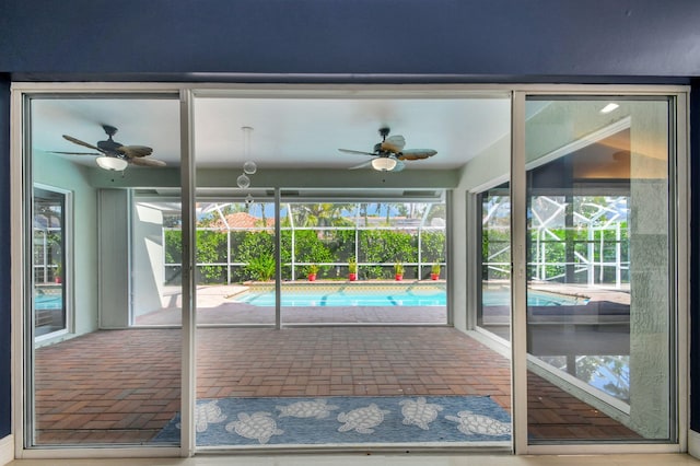 unfurnished sunroom featuring ceiling fan