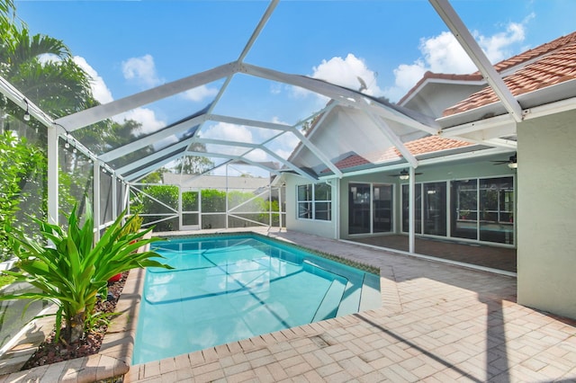 view of pool with a patio and glass enclosure