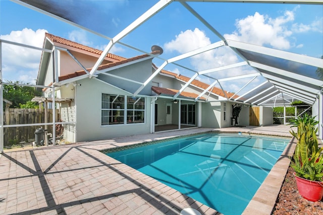 view of swimming pool featuring a patio and a lanai