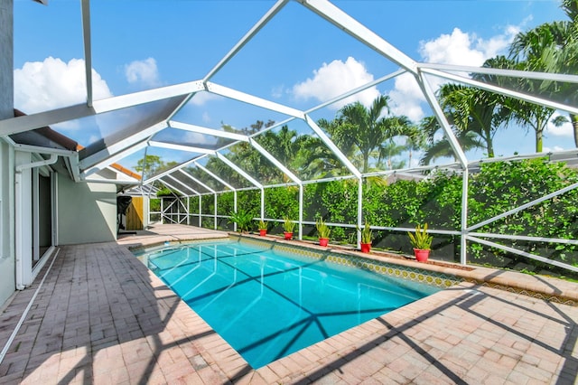 view of swimming pool with a patio and a lanai