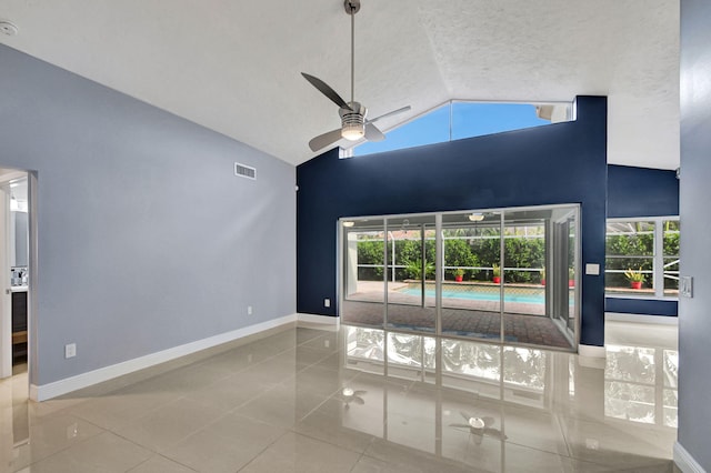 unfurnished living room featuring tile patterned floors, ceiling fan, and high vaulted ceiling