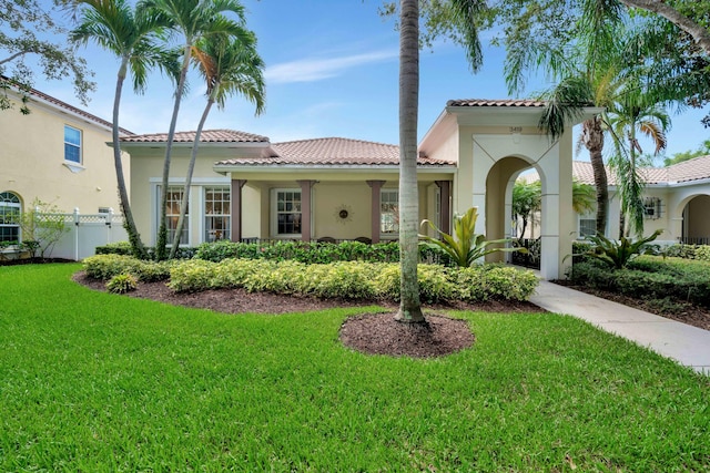 mediterranean / spanish-style home with a front lawn