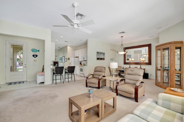 living room featuring light carpet and ceiling fan