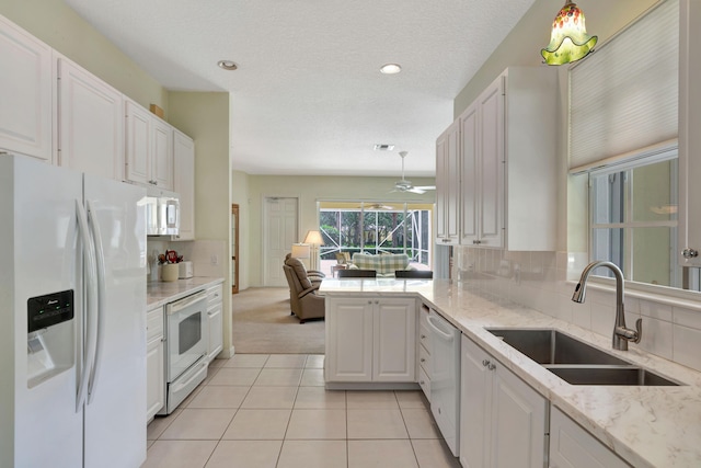 kitchen with white cabinetry, sink, backsplash, white appliances, and light tile patterned floors