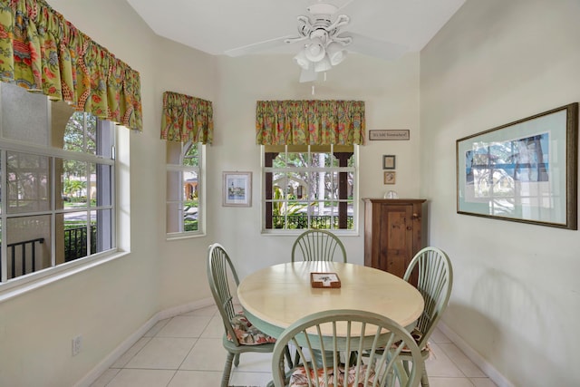 tiled dining room featuring ceiling fan