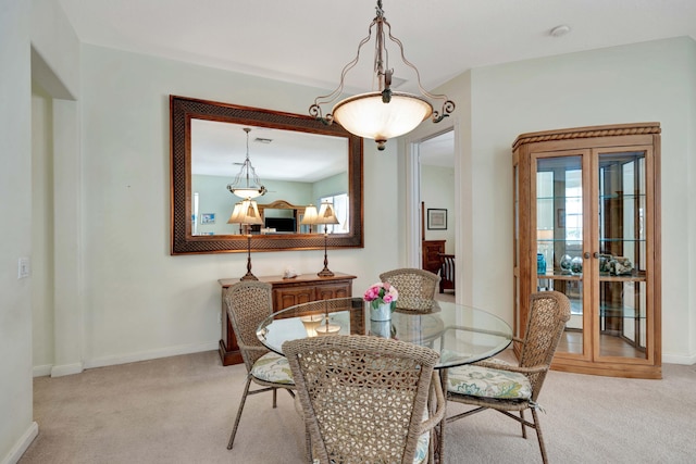 dining area with light colored carpet and french doors