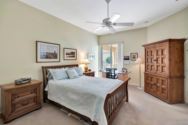 bedroom with a textured ceiling, ceiling fan, and light carpet