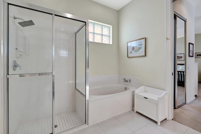 bathroom with tile patterned floors and independent shower and bath