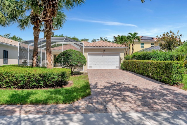 mediterranean / spanish home featuring a lanai and a garage