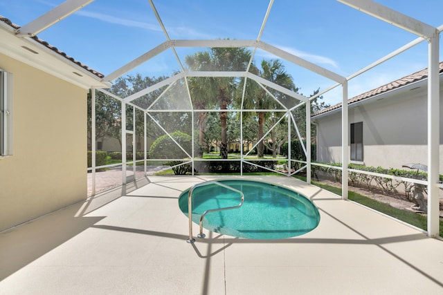 view of pool featuring a lanai and a patio